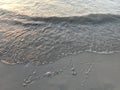 Sea wave erase year 2017 on the beach